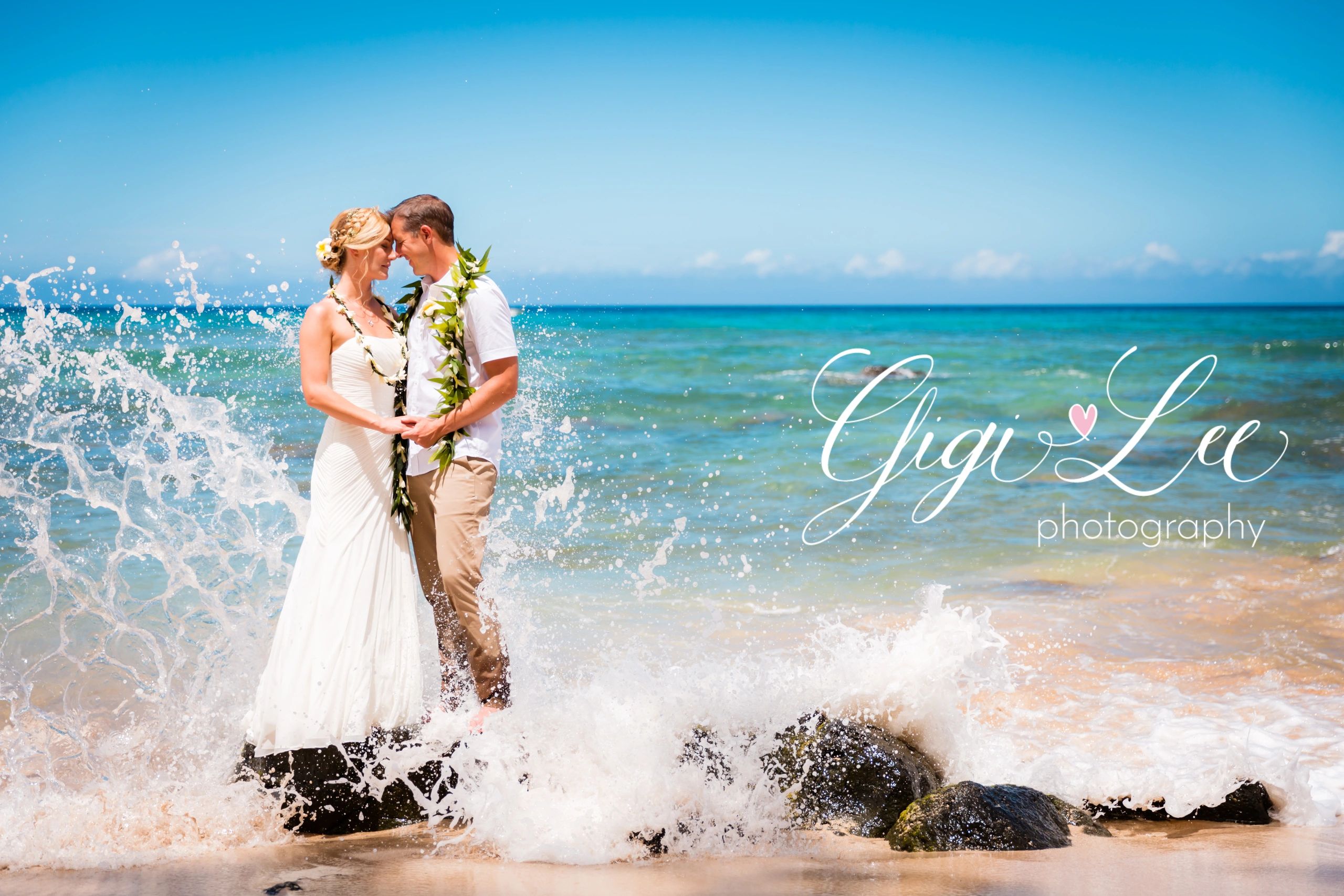 Couple in ocean surf Hawaii wedding